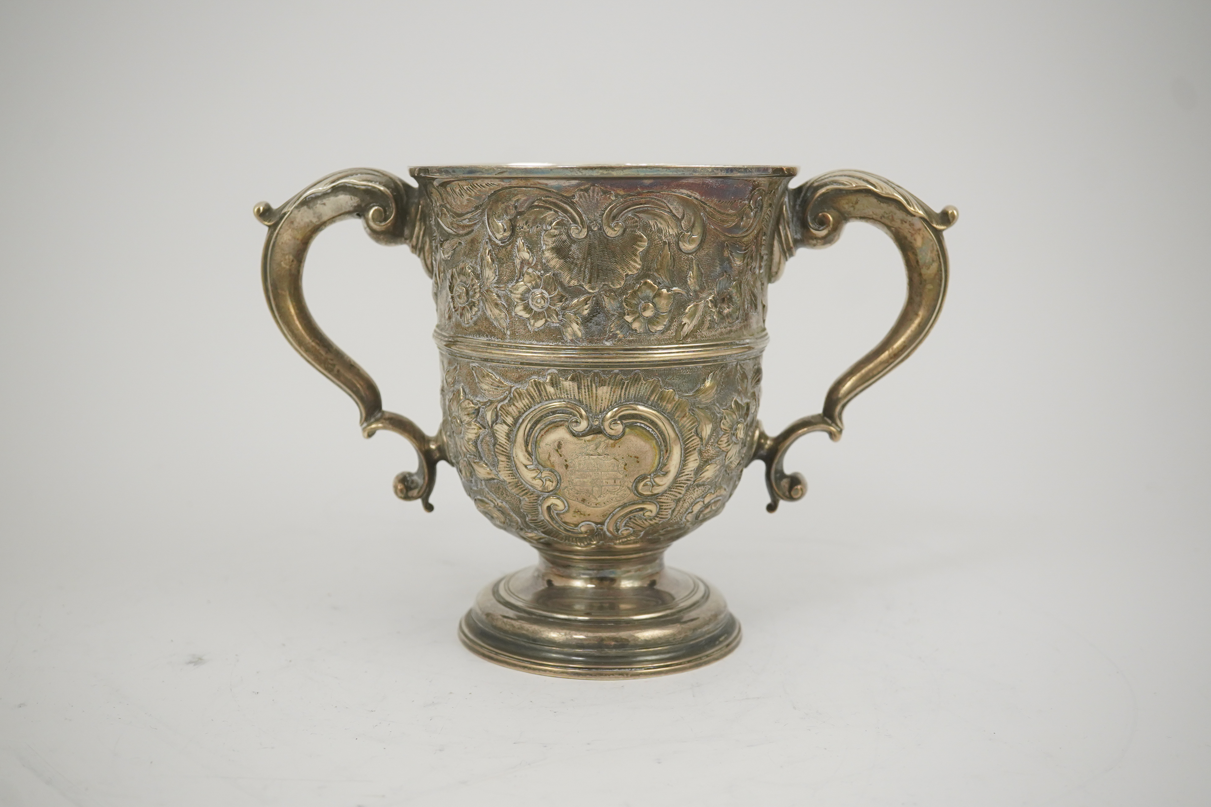 A George II silver loving cup with later floral embossed decoration, maker's initials RI, London, 1745